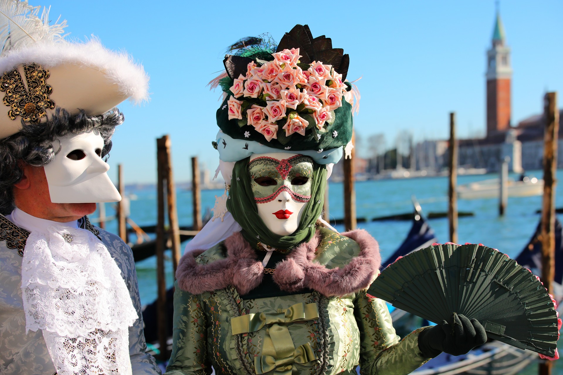 Copuple with Venetian Mask at Venice Carnival by the lagoon